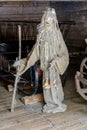 Doll in MeteÃâ i mumming mask and costume of an elder staying in old wooden cart-house